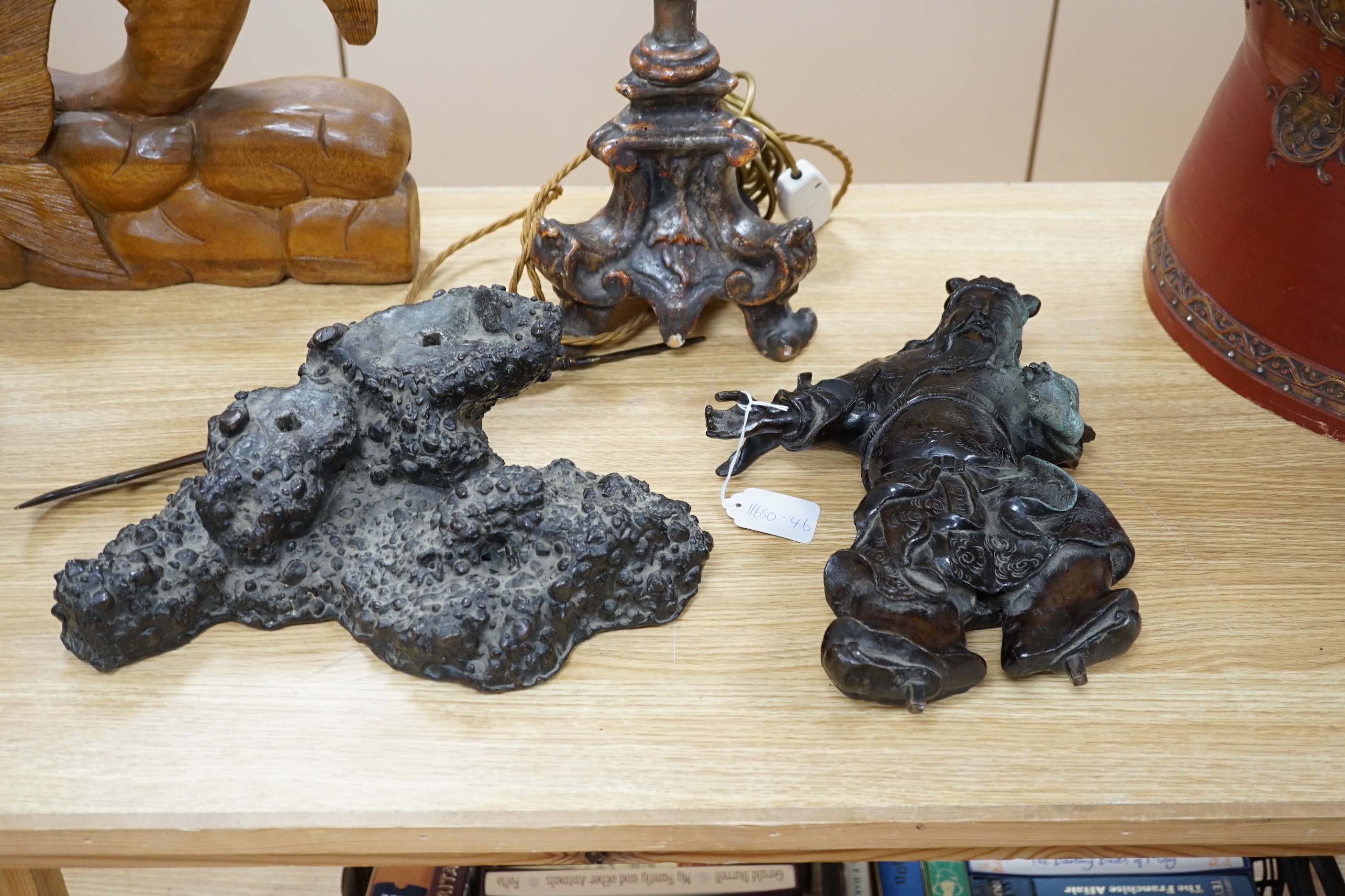 A 19th century Japanese bronze figure of a warrior, raised on naturalist bronze base, 40cm high